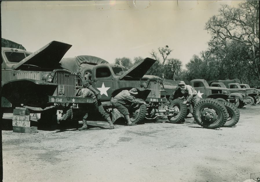 548th Ord H M Co. (FA) Repair Line 1 - 2 Ton. Vehicle on the left is to be evacuated so its front end is used to repair the other truck. Interchanging parts in this manner eliminates the necessity of deadlining 2 vehicles.JPG